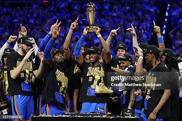 Shai Gilgeous-Alexander of the Oklahoma City Thunder celebrates with the Bill Russell NBA Finals Most Valuable Player trophy after defeating the...