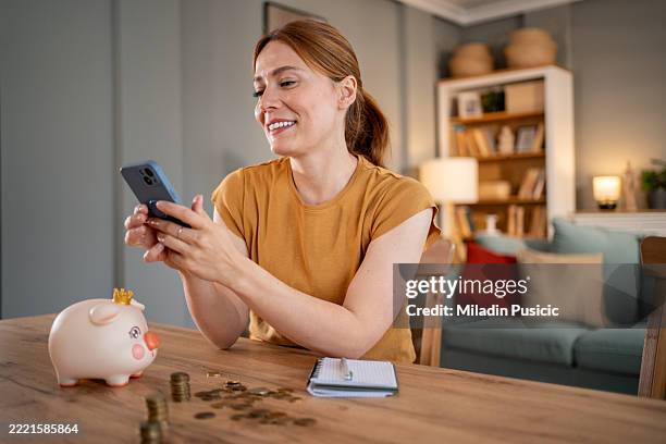 woman managing home finances using mobile banking app - financial literacy stock pictures, royalty-free photos & images