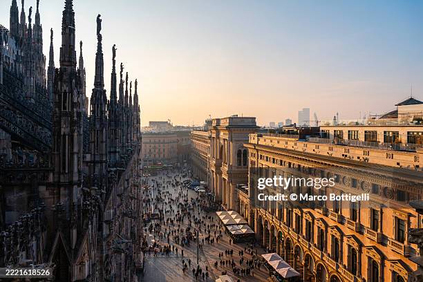the facade of galleria vittorio emanuele ii and duomo's spires, milan, italy. high angle view - milão imagens e fotografias de stock