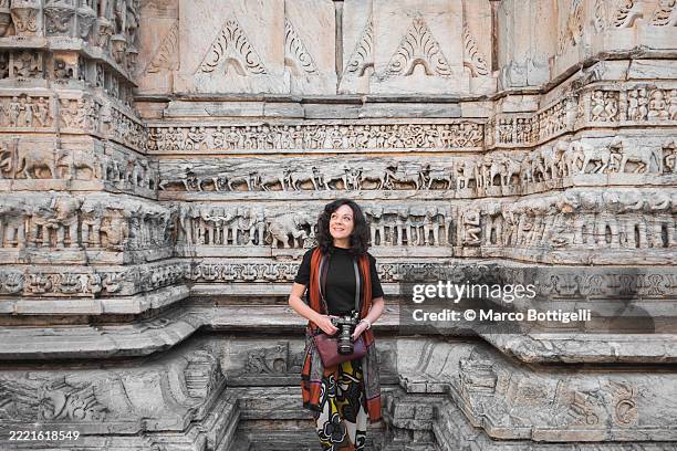 woman enjoying historical architecture at jagdish temple in udaipur, india - pilgrimage stock pictures, royalty-free photos & images