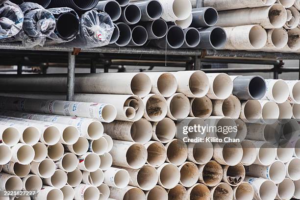 piles of steel and pvc pipes on shelf - pvc fotografías e imágenes de stock