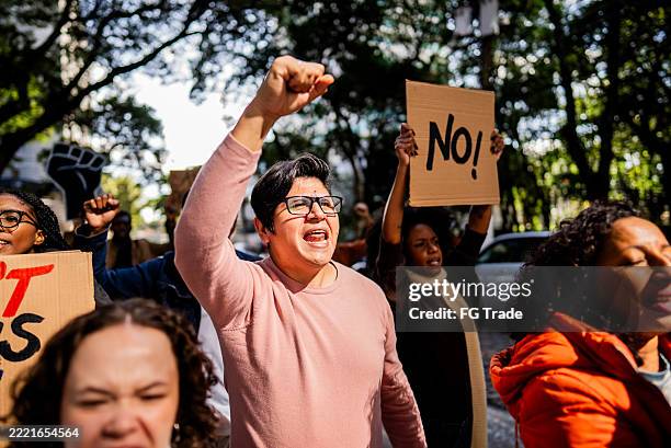 people protesting outdoors - protestor stock pictures, royalty-free photos & images