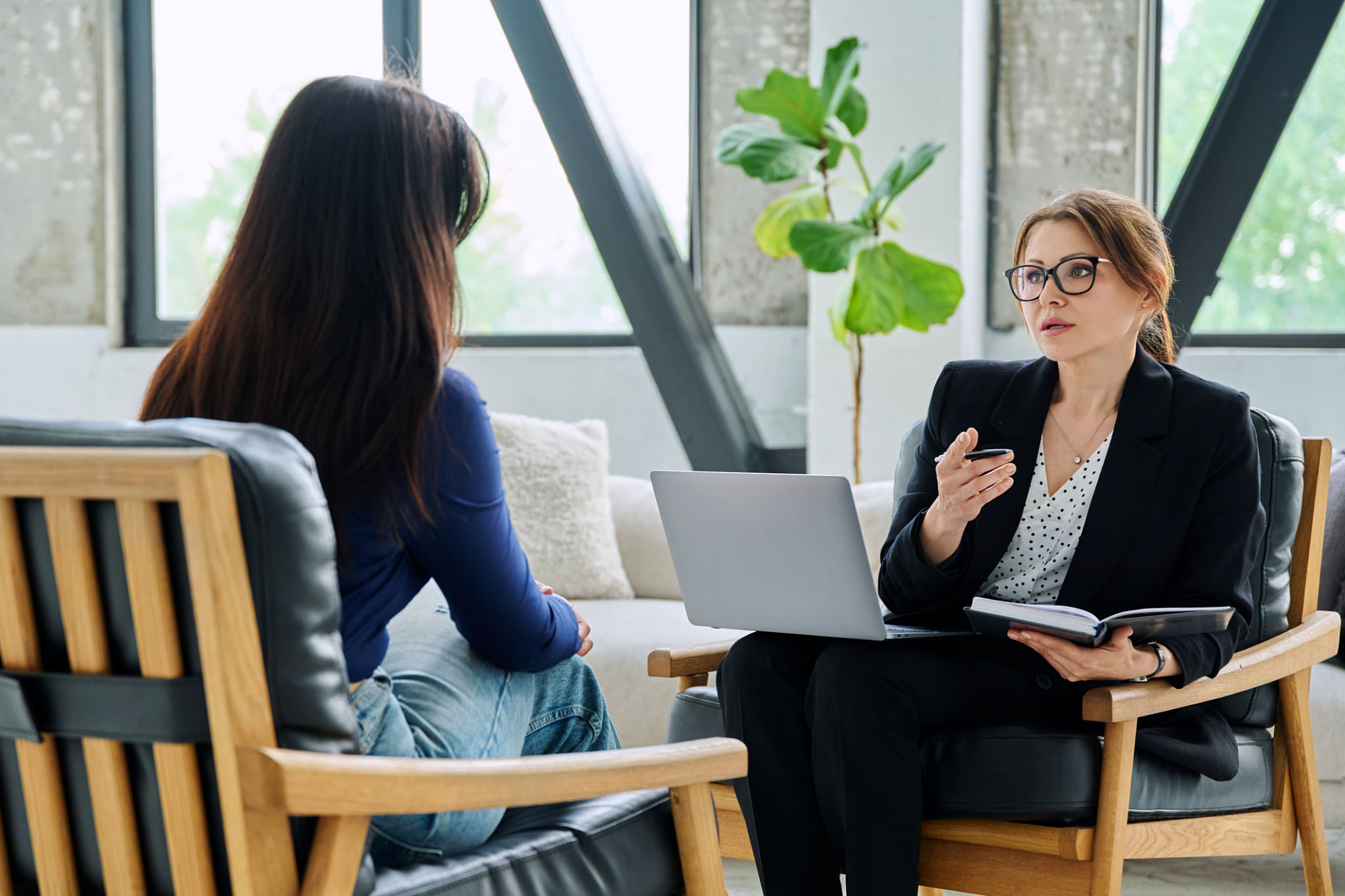 Female mental health professional working with young woman Female mental health professional working with young woman