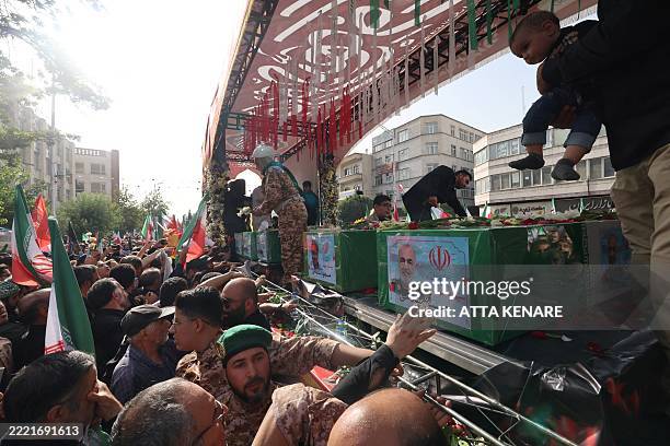 Mourner reaches out to touch the coffin of Iranian Islamic Revolutionary Guard Corps commander Hossein Salami , and other military commanders killed...