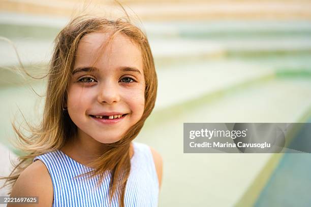 portrait of a smiley little girl with missing tooth - portrait of a young girl with gappy teeth and blond hair stock pictures, royalty-free photos & images