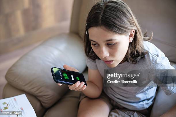 adolescente haciendo preguntas sobre la aplicación móvil ai chatbot usando su teléfono inteligente - responder fotografías e imágenes de stock