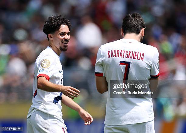 Khvicha Kvaratskhelia of Paris Saint-Germain celebrates with Vitinha after scoring his team's first goal during the FIFA Club World Cup 2025 group B...