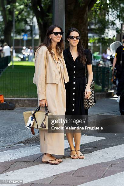 Guest wears black cat-eye sunglasses, layered gold necklaces, a sand beige cotton shirt jacket with "Miu Miu" logo embroidery, a matching relaxed-fit...