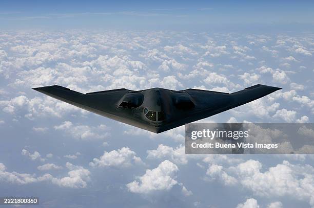 northrop grumman b-2 spirit flying over clouds. - stealth bomber foto e immagini stock