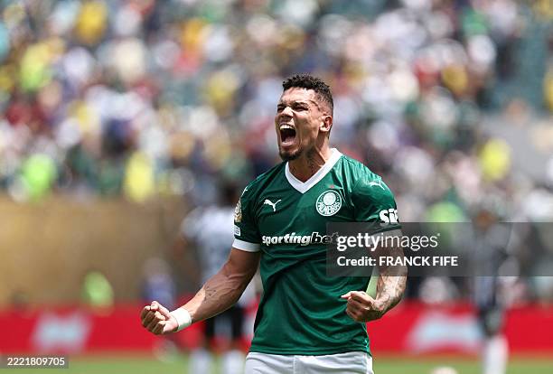 Palmeiras' Brazilian forward Paulinho celebrates after scoring the opening goal during the FIFA Club World Cup 2025 round of 16 all-Brazilian...