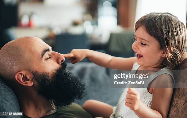 toddler girl and her father are having fun at home - modern manhood stock pictures, royalty-free photos & images