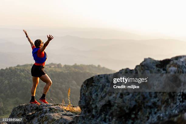 woman taking a break from running in the mountains - mountain ridge stock pictures, royalty-free photos & images
