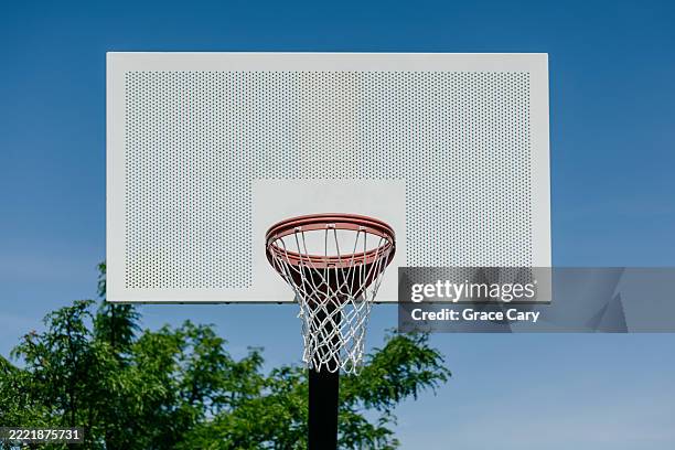 basketball hoop and backboard against blue sky - basketball hoop stock pictures, royalty-free photos & images