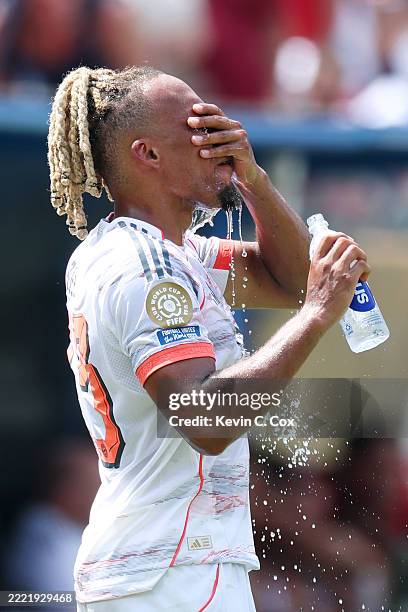 Sacha Boey of FC Bayern Munchen takes a hydration break during the FIFA Club World Cup 2025 group C match between SL Benfica and FC Bayern München at...