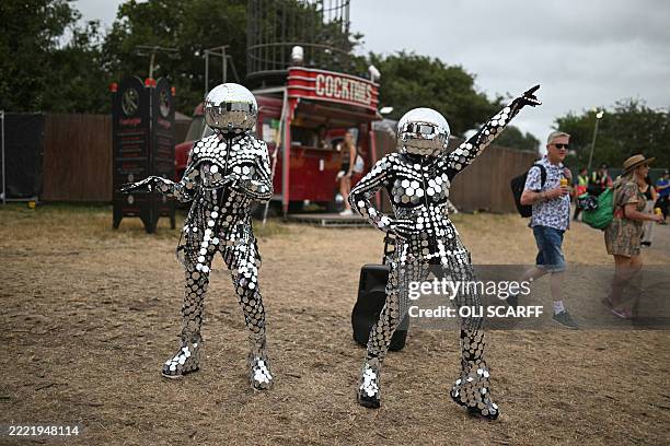 Performers entertain festivalgoers near to the Circus Field on the final day of the Glastonbury festival at Worthy Farm in the village of Pilton in...