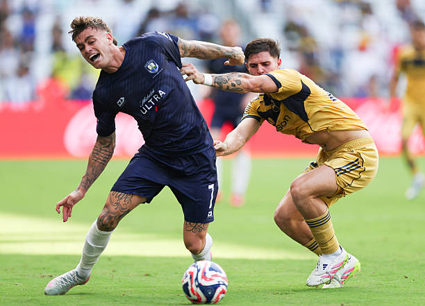 Myer Bevan of Auckland City FC is challenged by Marco Pellegrino of CA Boca Juniors during the FIFA Club World Cup 2025 group C match between...
