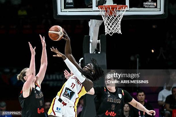 Spain's center Awa Fam passes the ball as she is defended by Belgium's power forward Emma Meesseman and Belgium's center Kyara Linskens during the...