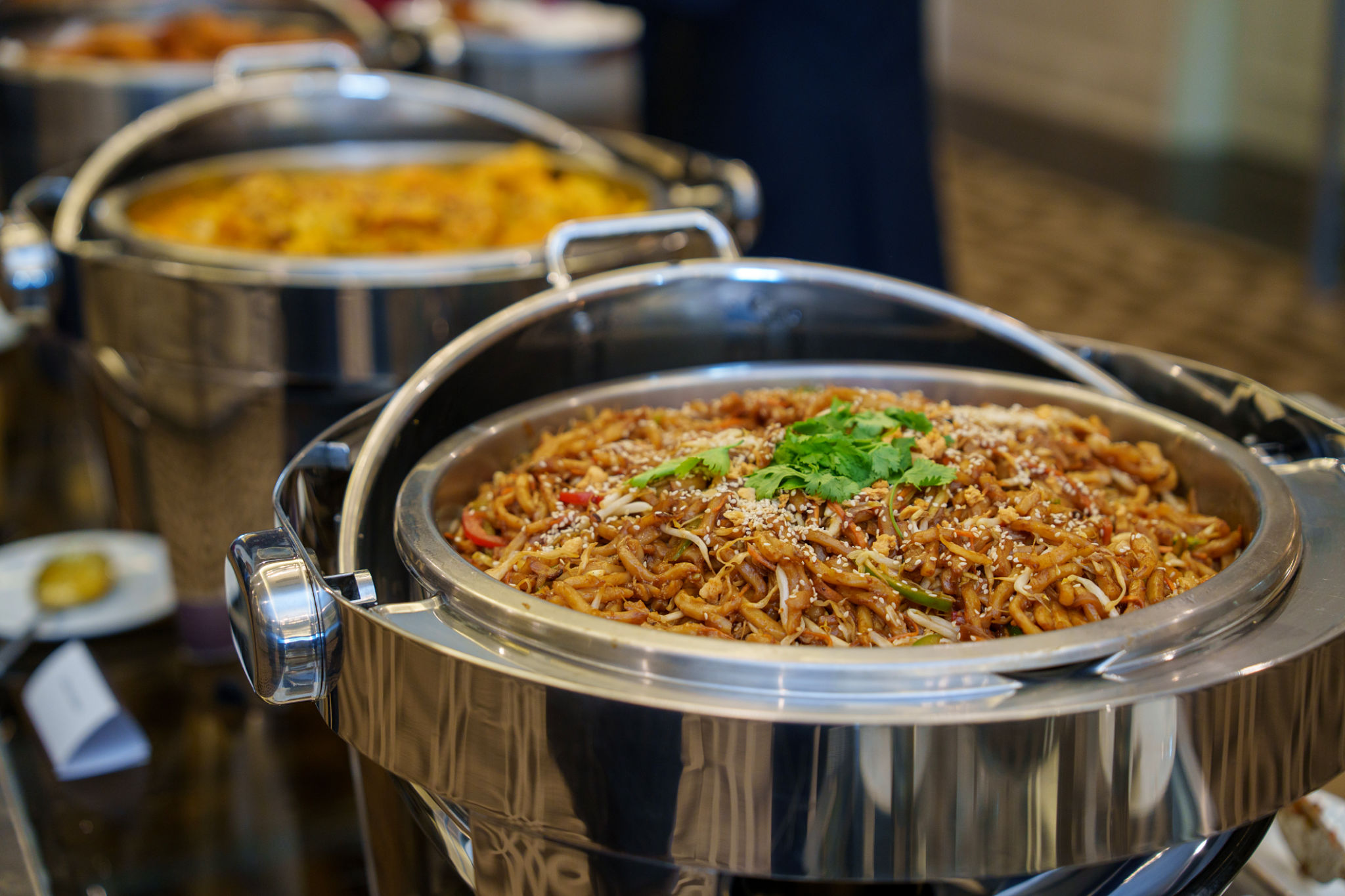 Stir-fried noodles served at buffet counter Stir-fried noodles served at buffet counter