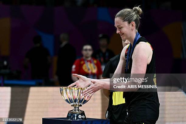 Belgium's power forward Emma Meesseman takes the trophy after winning the 2025 FIBA Women's EuroBasket following Belgium's final match against Spain...