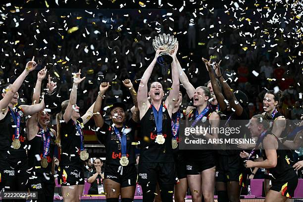 Belgium's power forward Emma Meesseman holds the trophy and celebrates with teammates winning the 2025 FIBA Women's EuroBasket after their final...