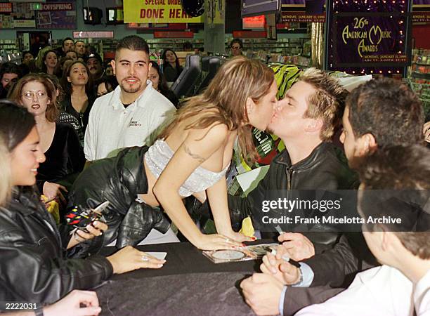 Sugar Ray singer Mark McGrath kisses a fan at the Tower Records store on Sunset Blvd in Hollywood, California where the band signed copies of their...
