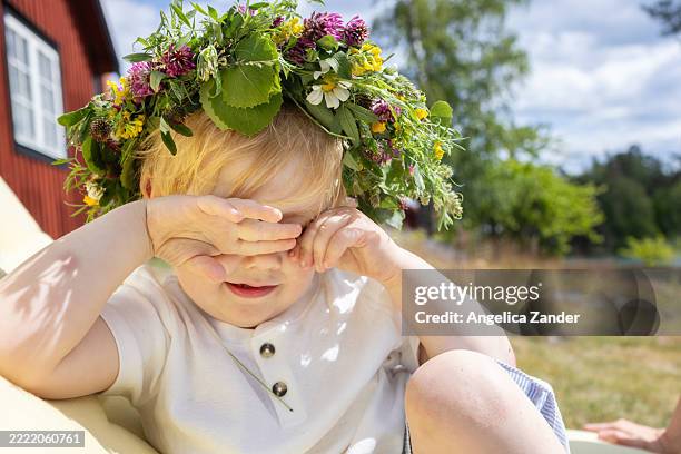 child with a flower crown rubbing his eyes - kid rubbing eyes stock pictures, royalty-free photos & images