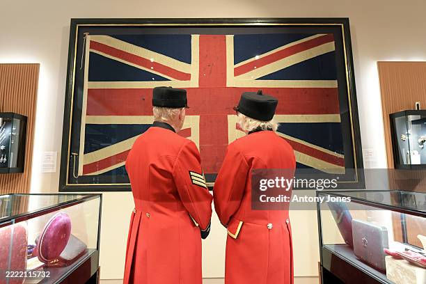 Chelsea Pensioners pose with The Union flag worn by The Royal Sovereign, the ship that led the British fleet into the Battle of Trafalgar at the...