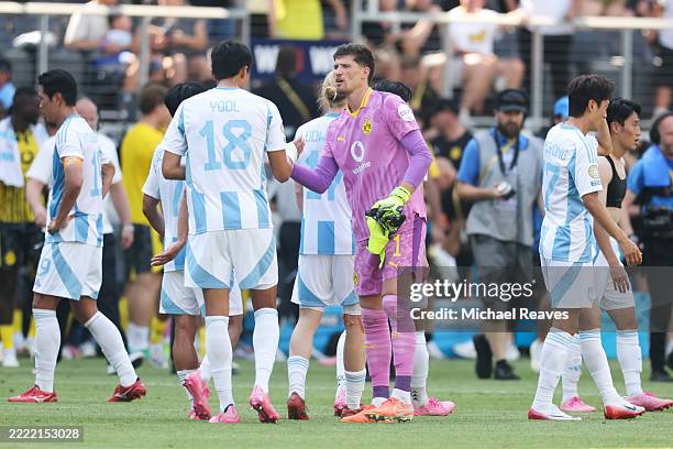 Gregor Kobel of Borussia Dortmund embraces Heo Yool of Ulsan HD following the FIFA Club World Cup 2025 group F match between Borussia Dortmund and...