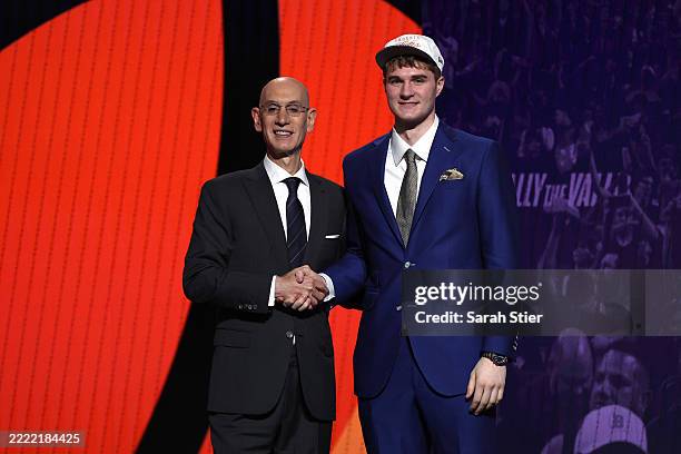 Liam McNeeley shakes hands with NBA commissioner Adam Silver after being drafted twenty-ninth overall by the Phoenix Suns during the first round of...
