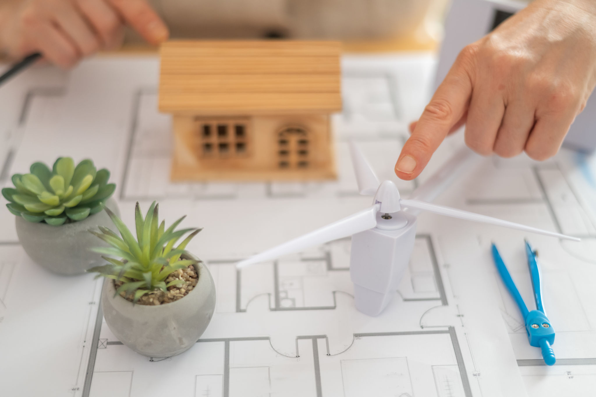 Architect designing a sustainable house powered by a wind turbine, emphasizing renewable energy and an ecological future while creating innovative solutions for green living Architect designing a sustainable house powered by a wind turbine, emphasizing renewable energy and an ecological future while creating innovative solutions for green living