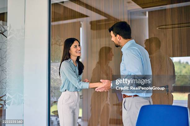 businesspeople shaking hands in modern office meeting room - respect stock pictures, royalty-free photos & images
