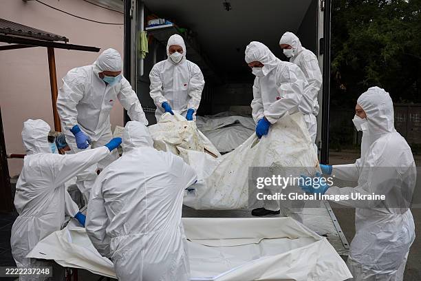 Forensic scientists unloaded from a truck onto a stretcher with bodies of fallen Ukrainian soldiers repatriated as part of the "6,000 For 6,000"...
