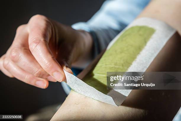 close-up of woman waxing her legs - waxing hair removal stock pictures, royalty-free photos & images