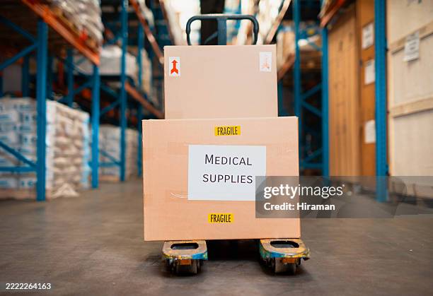 cajas de suministros médicos en un palé dentro de un ajetreado entorno de almacén logístico - material médico fotografías e imágenes de stock