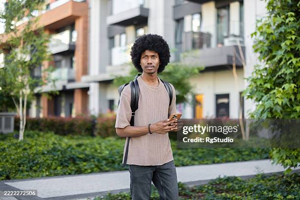 young student using smartphone on university campus - learning path stock pictures, royalty-free photos & images