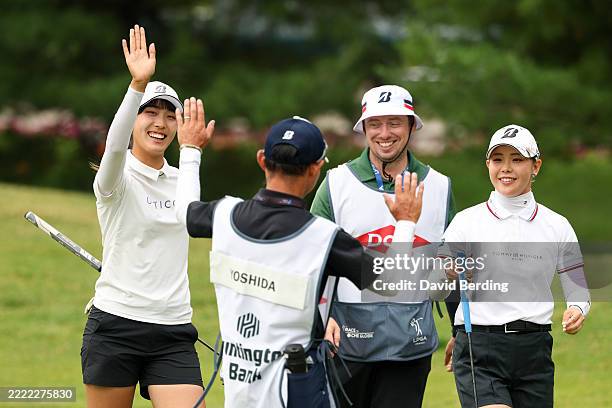 Saki Baba and Yuri Yoshida of Japan react after their putts on the fifth green during the first round of the Dow Championship 2025 at Midland Country...