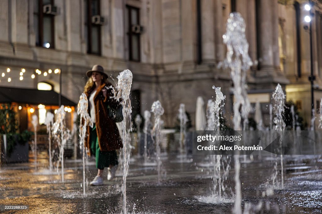 Fountain display near Philadelphia City Hall. Fifty-year-old tourist enjoys evening water feature during spring visit.