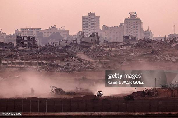 This picture taken from a position on the Israeli border with the Gaza Strip, shows an Israeli vehicle returning from the Palestinian territory on...