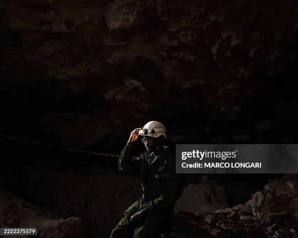 Tebogo Makhubela, a South African geologist recipient of one of the prestigious National Geographic 2025 Wayfinder Awards, dims the head lamp fixed...