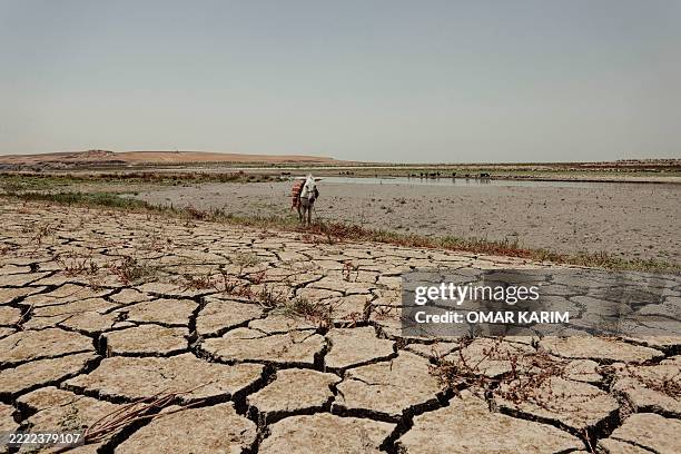 General view shows the dried-up areas of Lake Dukan, the largest lake in the Kurdistan Region, near Ranya in northeastern Iraq, on June 30,...