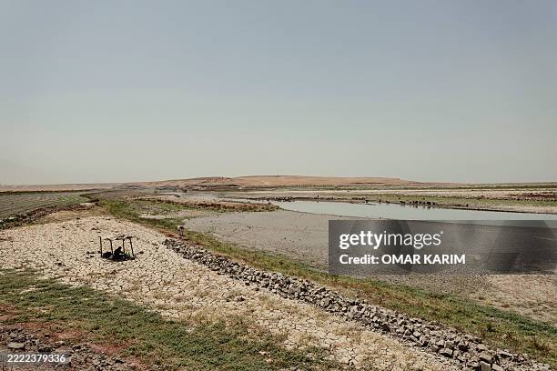 General view shows the dried-up areas of Lake Dukan, the largest lake in the Kurdistan Region, near Ranya in northeastern Iraq, on June 30,...