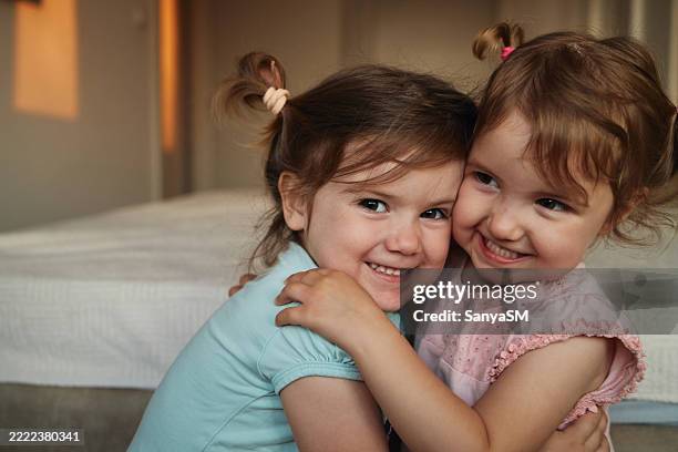 young twin girls playing in the bedroom - sister stock pictures, royalty-free photos & images