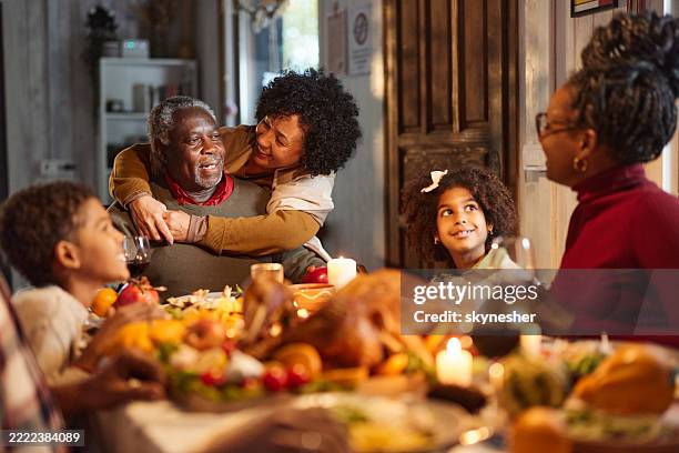 happy black grandparents enjoying with their family during lunch on thanksgiving. - african-american-family-thanksgiving stock pictures, royalty-free photos & images