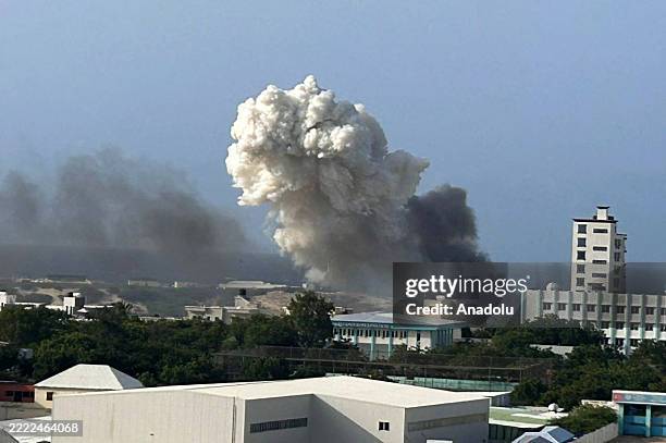 Smoke rises after a helicopter, belonging to the African Union Support and Stabilization Mission in Somalia , crashes during landing at Aden Adde...