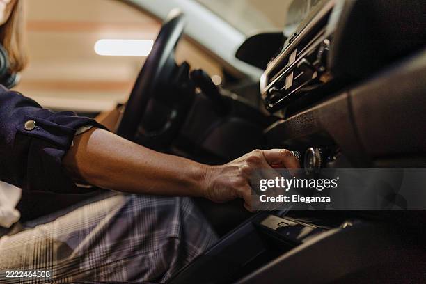 elegant woman's hand adjusting location and directions on gps in her car - location tracking stock pictures, royalty-free photos & images