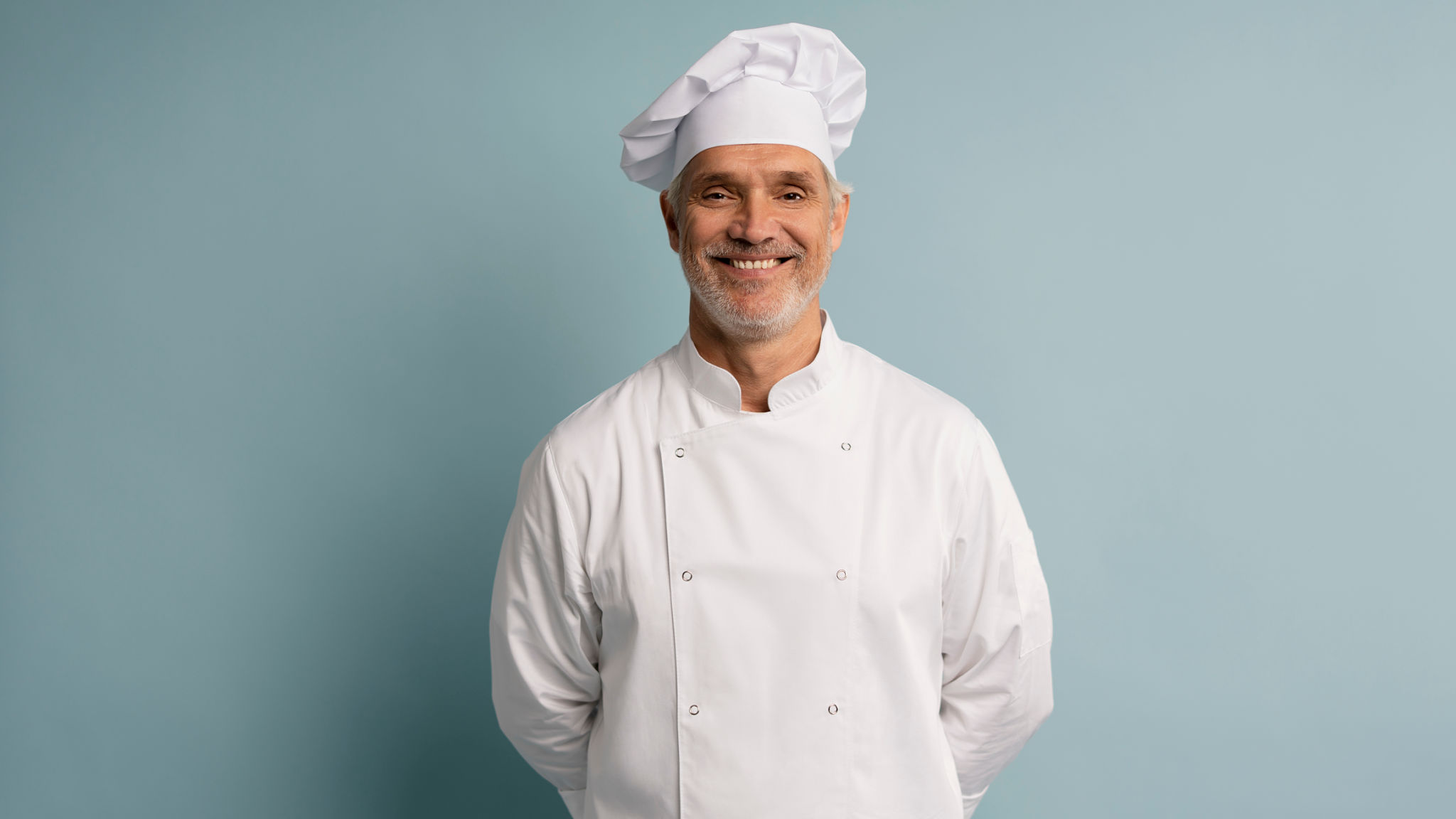 Happy chef in uniform on blue background. Happy chef in uniform on blue background.