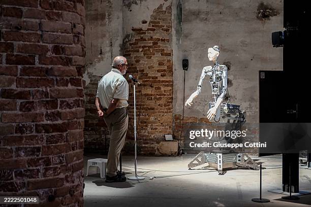 Visitor attends the work "Am I a Strange Loop?" by Takashi Ikegami and Luc Steels, exhibited in the Corderie Pavilion during the 19th International...