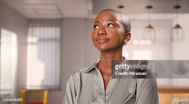 confident professional woman in a modern office interior setting - ciclo de vida imagens e fotografias de stock