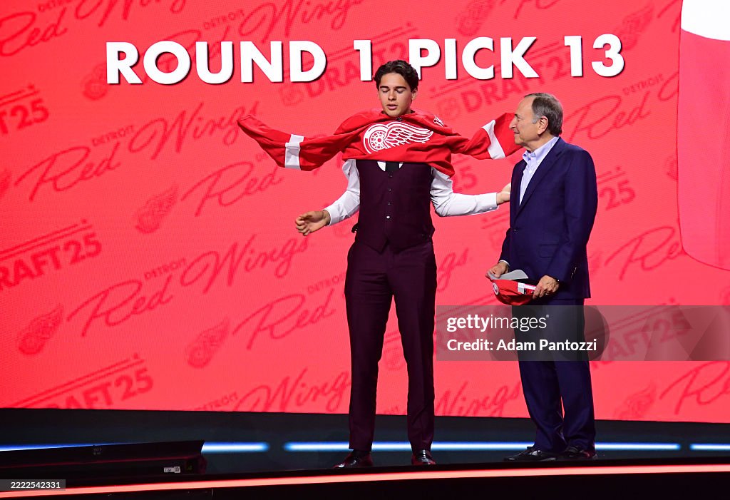 Carter Bear puts on his jersey next to NHL Commissioner Gary