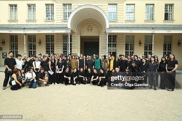 Designer Yosuke Aizawa poses with his team backstage prior to the White Mountaineering Menswear Spring/Summer 2026 show as part of Paris Fashion Week...